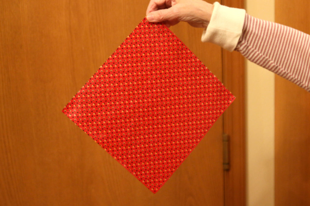 Wave it around: Once all parts of the wrap are saturated with wax, remove it from the oven and wave it around until it hardens, about a minute.